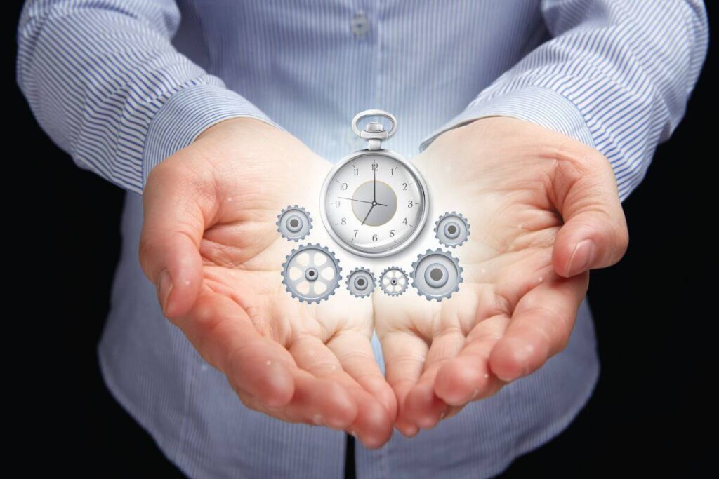 Hands holding a clock with gears representing time management, productivity, and efficient study for exams.